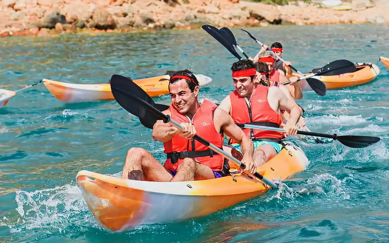 tandem kayakers racing in river - H2QO Watersport