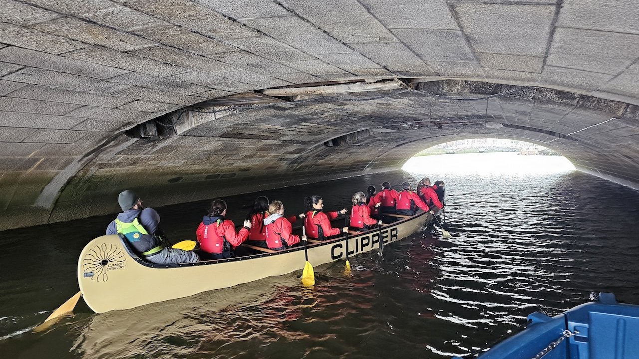 big canoe under bridge